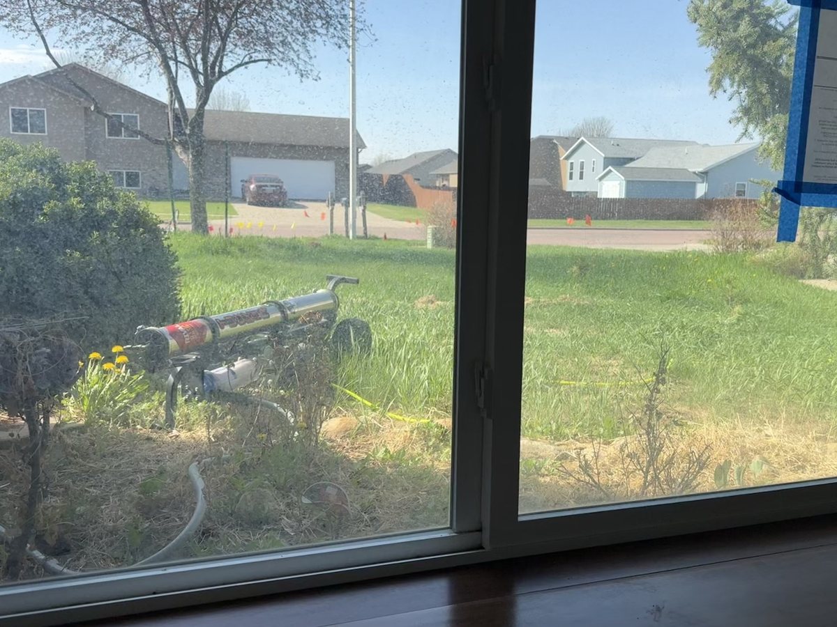 The same window before cleaning, with a hazy construction film on the glass