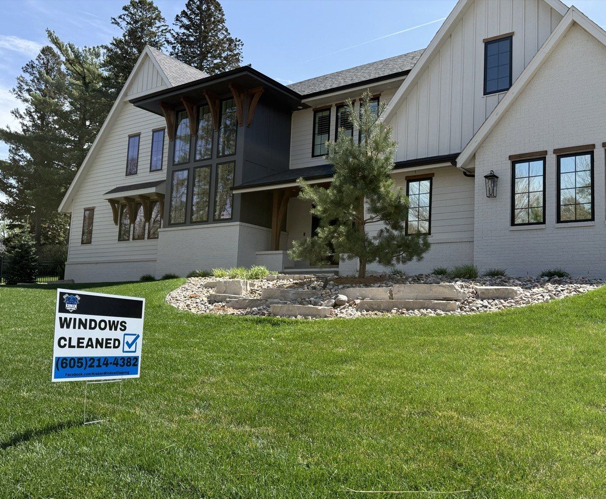 Sioux Falls home with freshly cleaned windows and a Kraken Window Cleaning yard sign