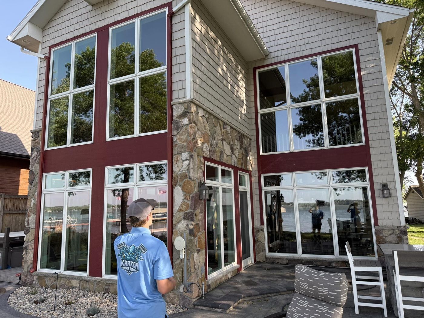 Cleaning tall windows on a Sioux Falls home